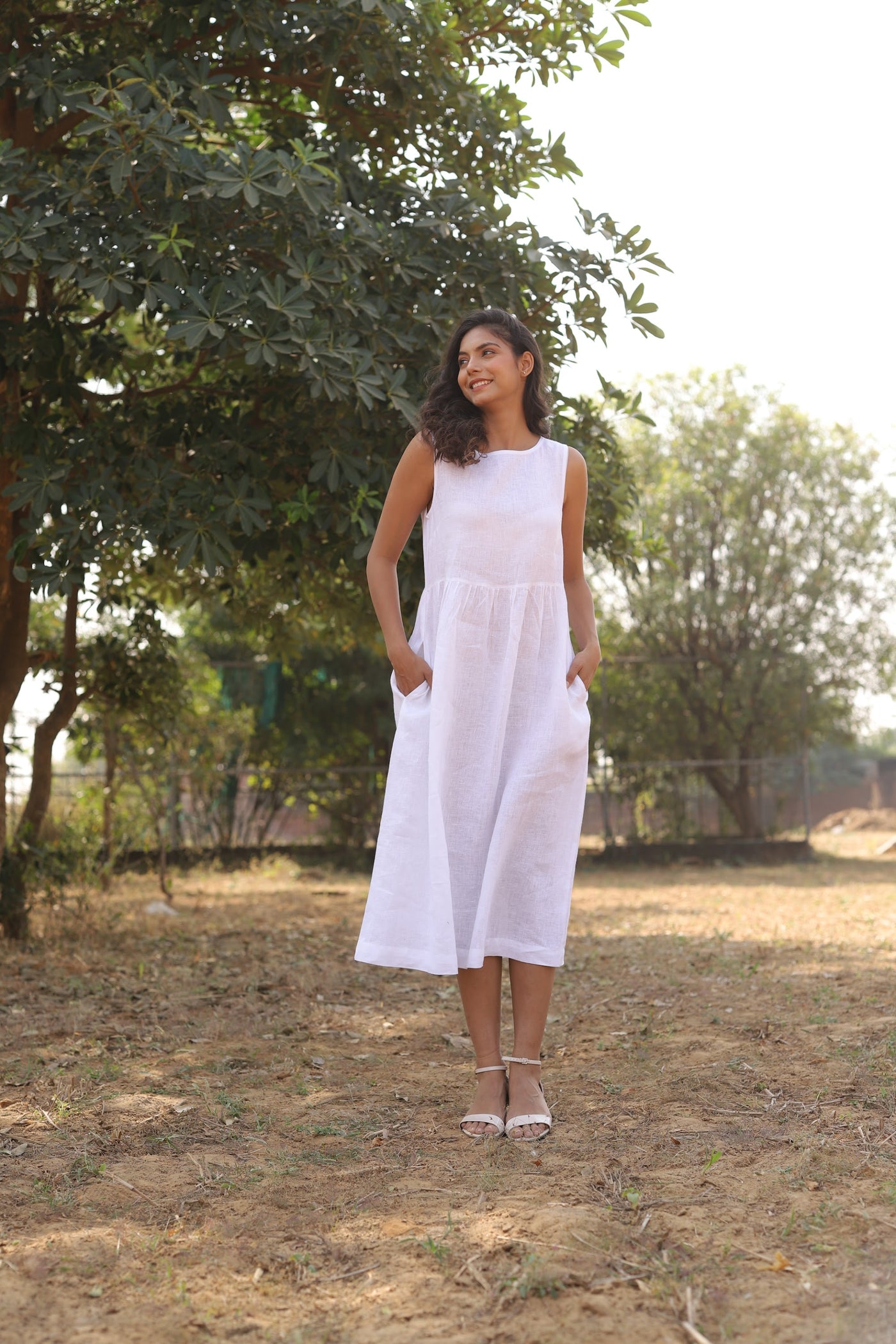 White sleeveless linen midi dress in washed linen, photographed in Jaipur