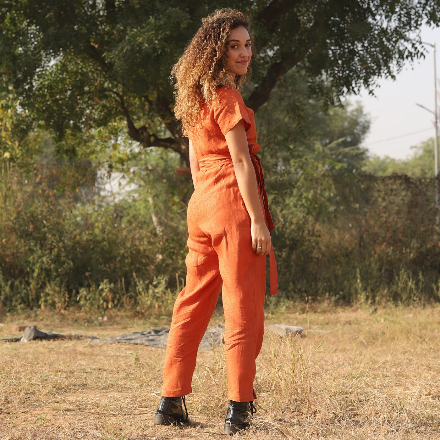 Rust wrap linen jumpsuit in washed linen, photographed in Jaipur