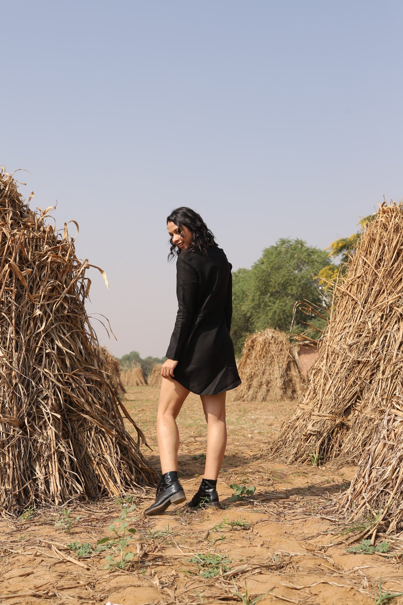 Black drawstring waist mini dress in washed linen, photographed in Jaipur