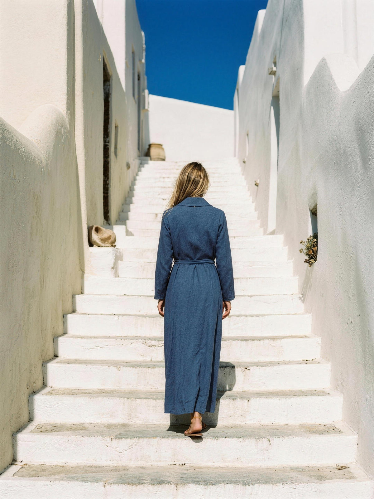 Indigo linen wrap maxi dress photographed on a whitewashed rooftop terrace