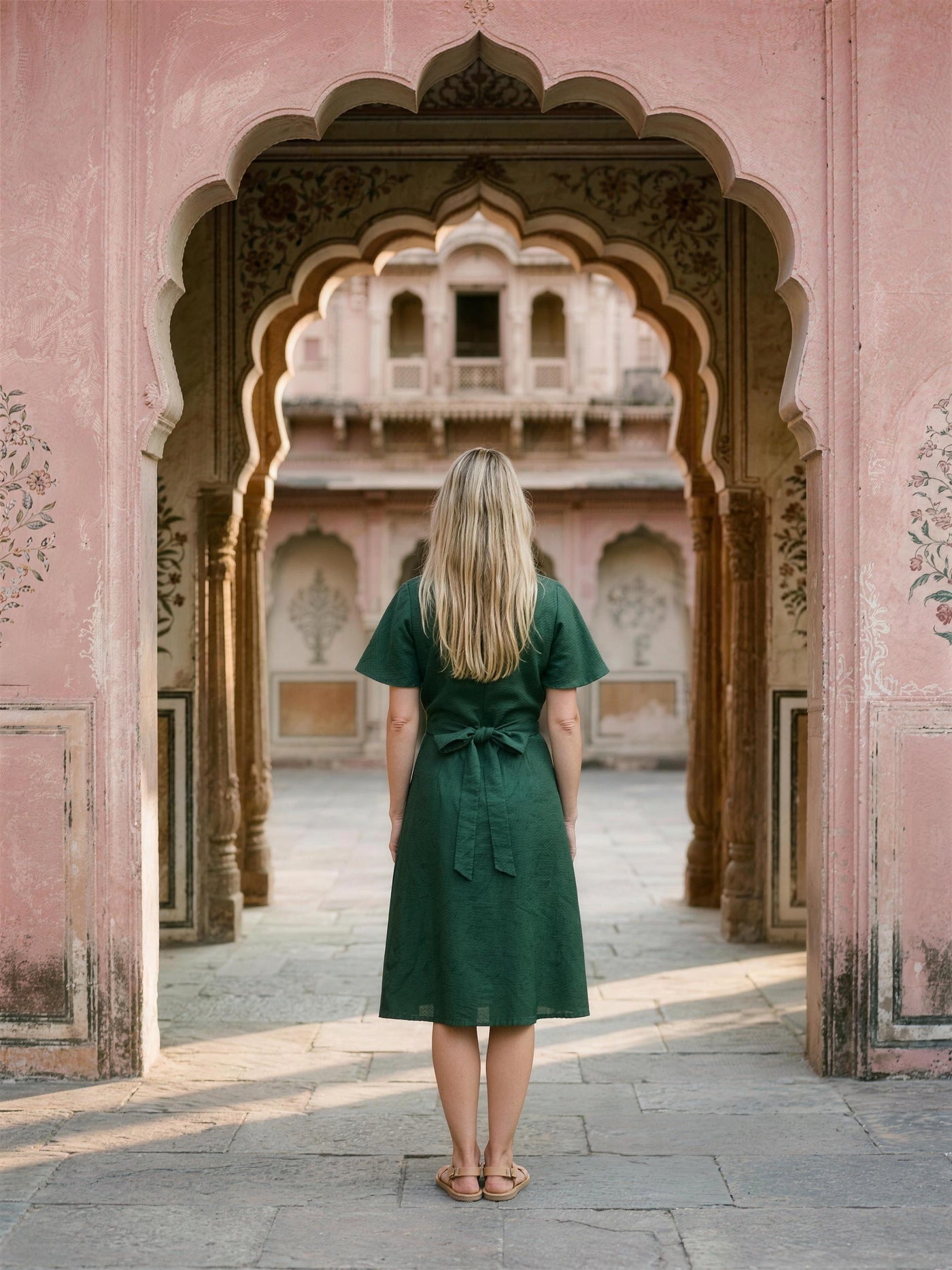 Bottle green linen wrap dress photographed in a Jaipur haveli courtyard