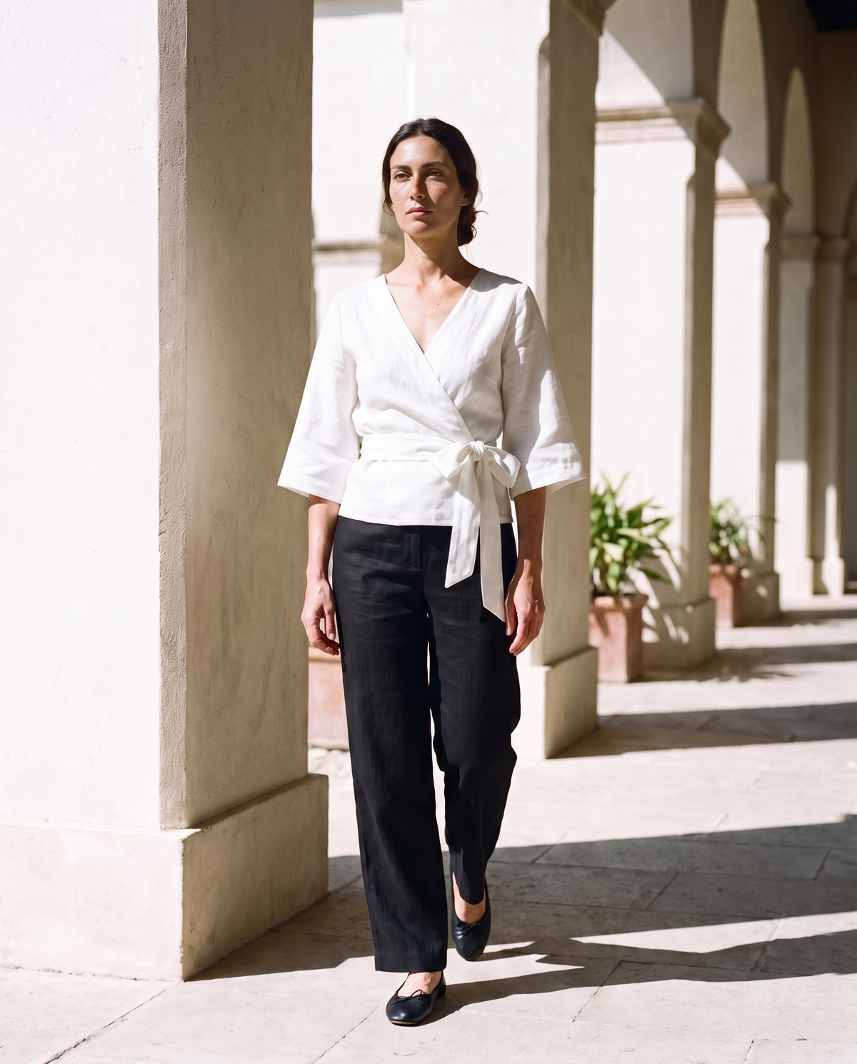 Lucia Wrap Top in white, styled with the straight leg trousers