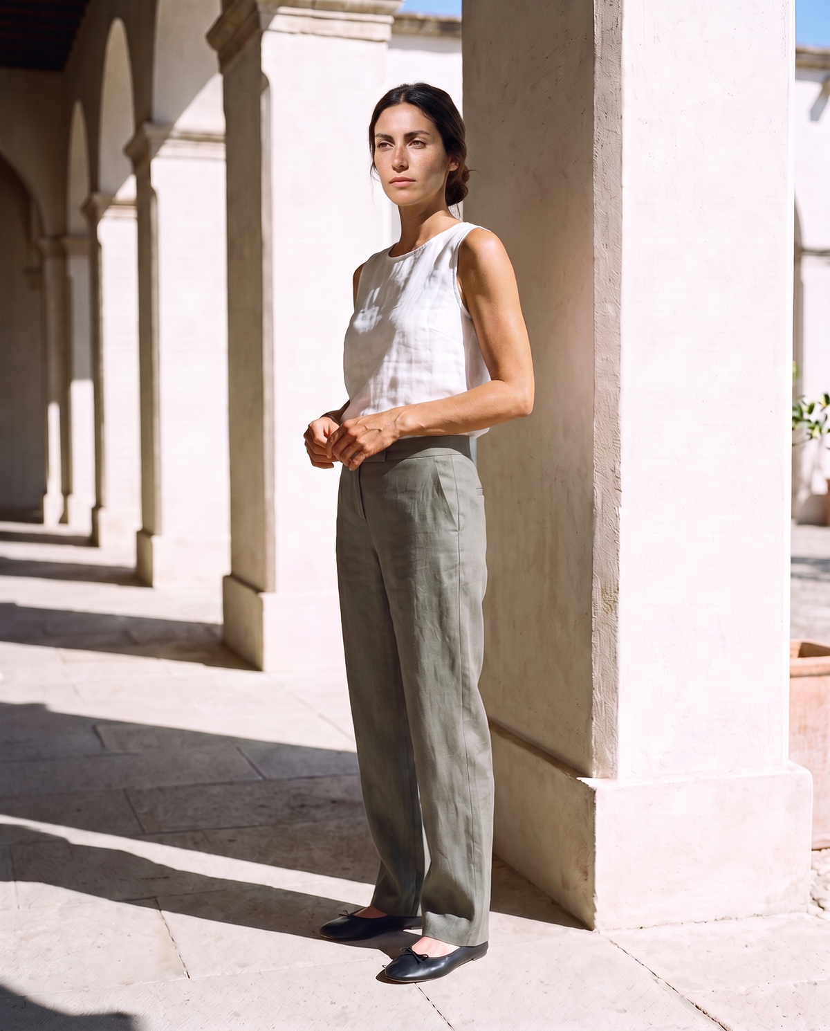 Nina Trousers in moss, a quarter turn, looking at the camera