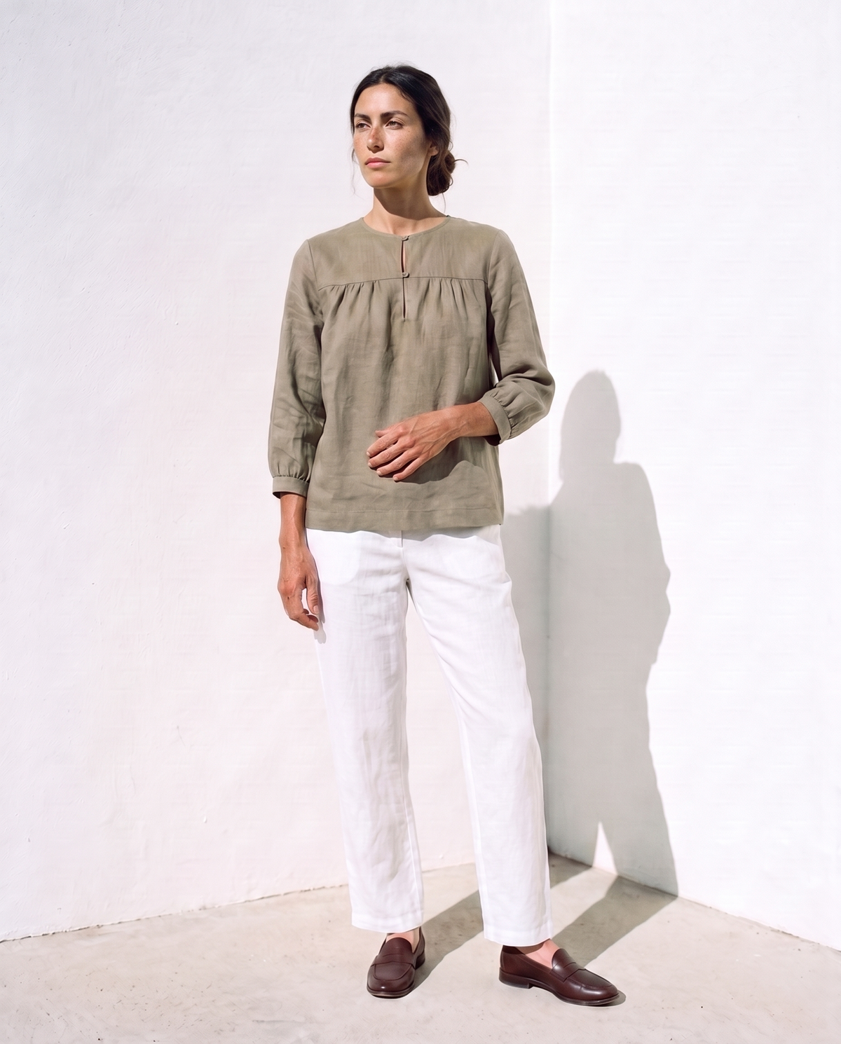 Ines Blouse in moss, face tilted up to the sun