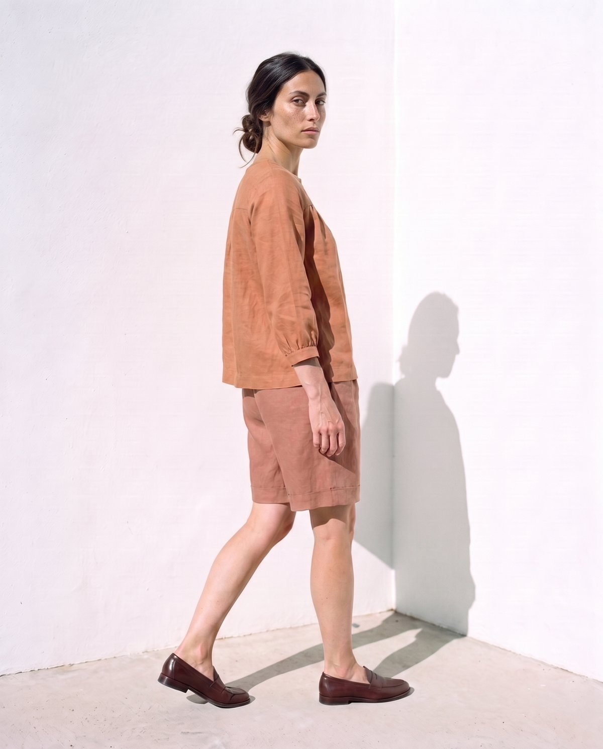 Ines & Rosa Set in clay, turning as she walks away