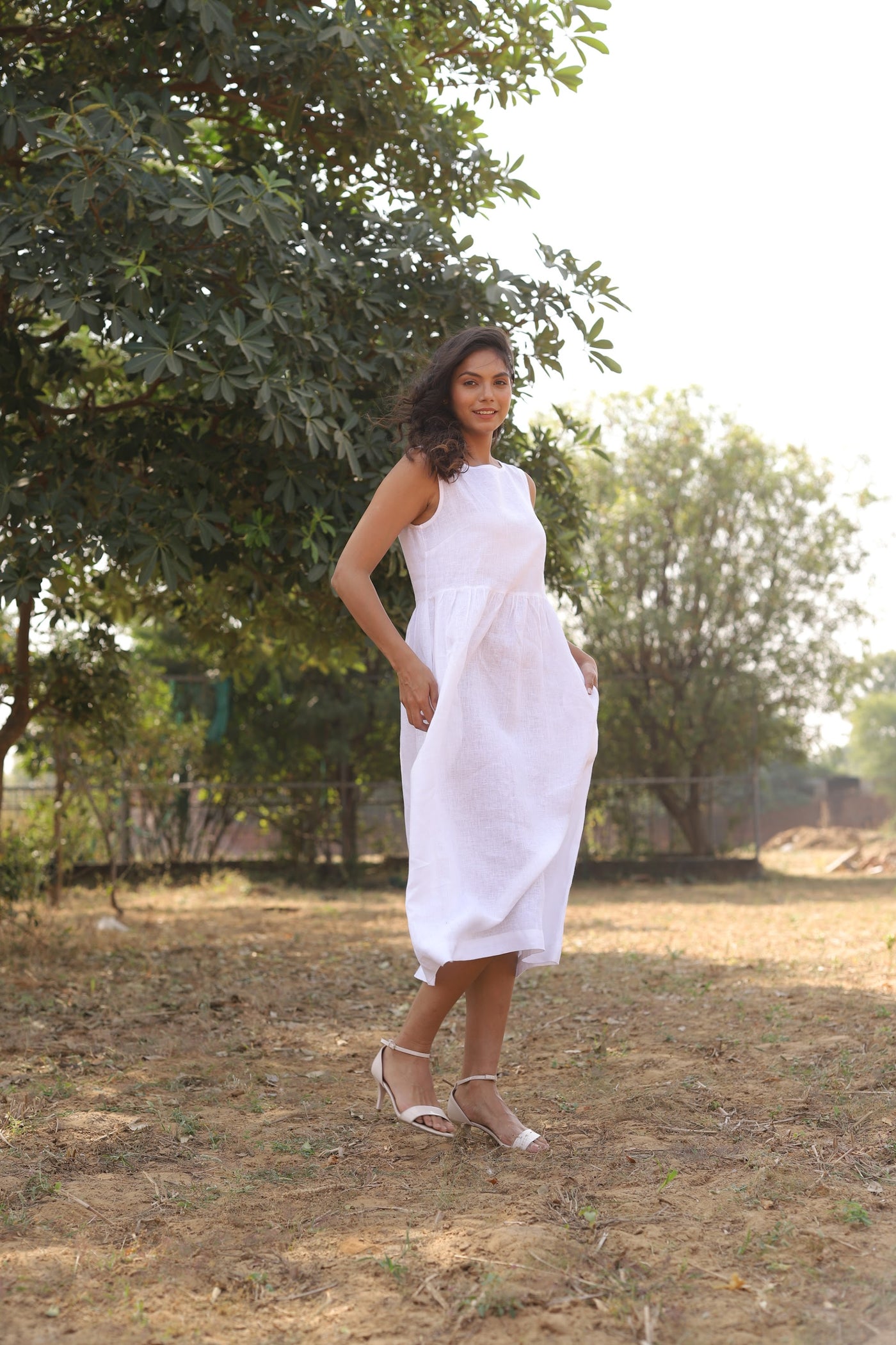 White sleeveless linen midi dress in washed linen, photographed in Jaipur