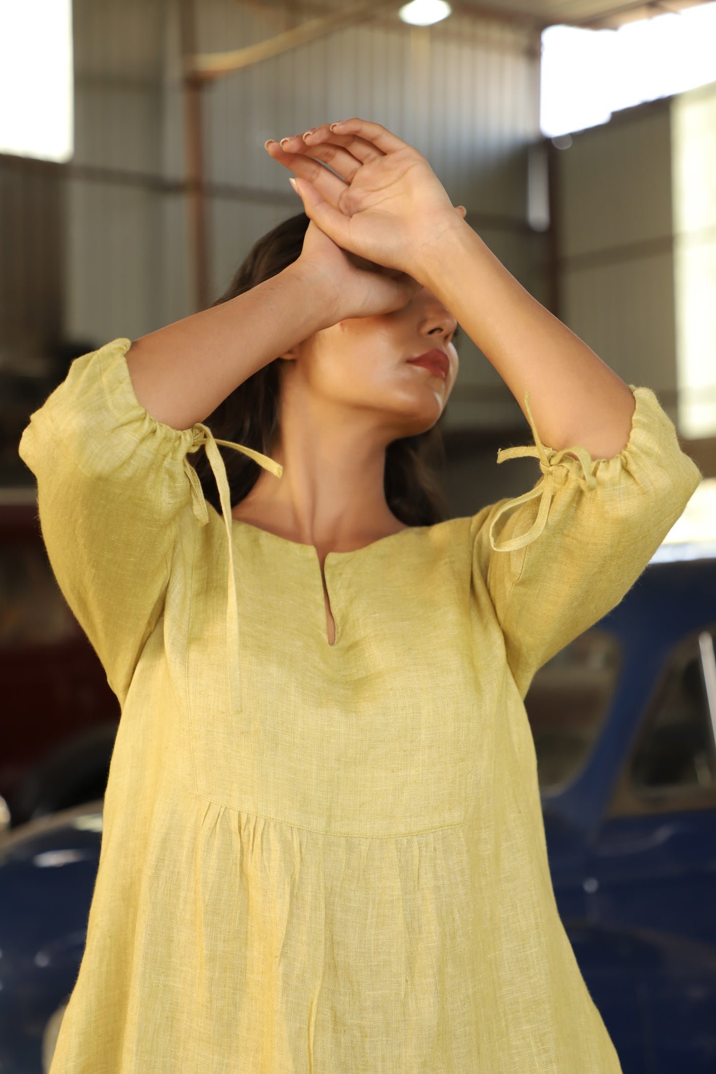 Chartreuse gathered yoke linen dress in washed linen, photographed in Jaipur