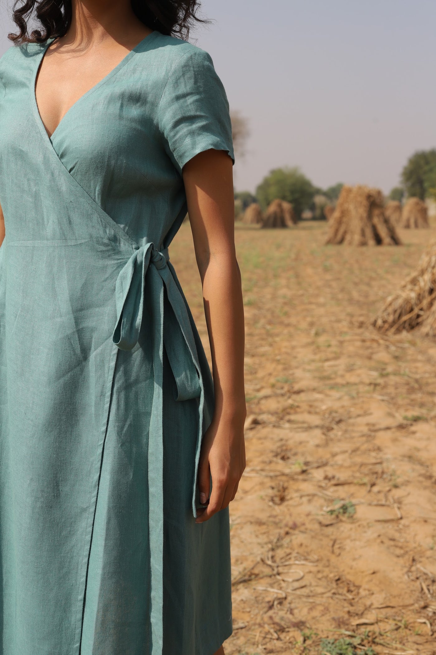 Teal wrap linen midi dress in washed linen, photographed in Jaipur