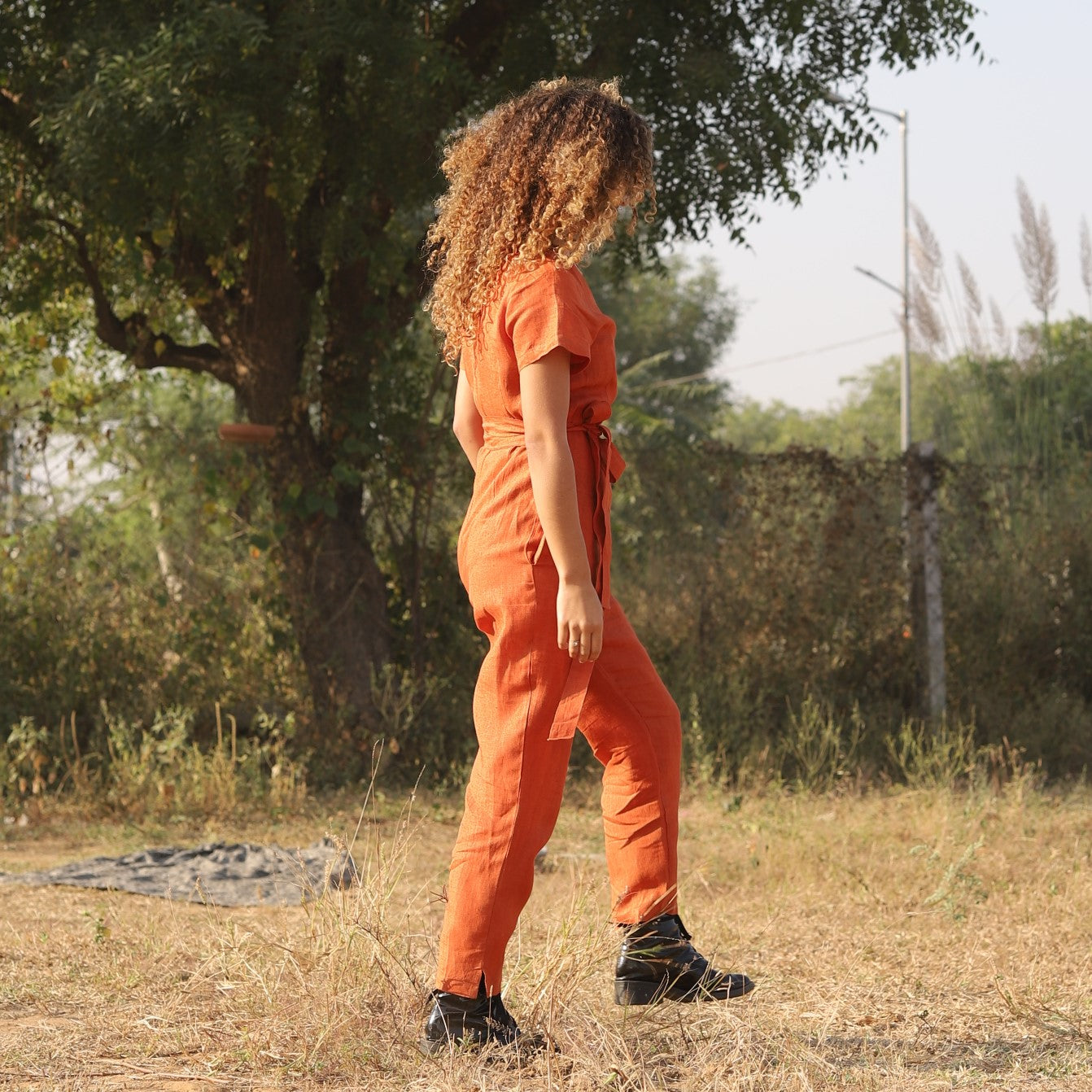 Rust wrap linen jumpsuit in washed linen, photographed in Jaipur