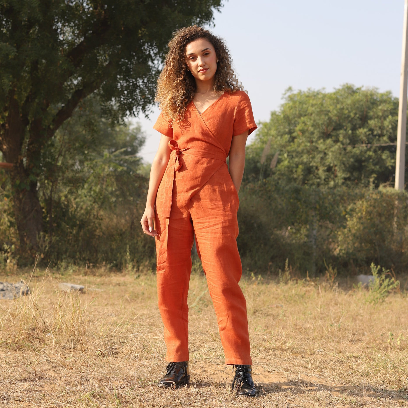 Rust wrap linen jumpsuit in washed linen, photographed in Jaipur
