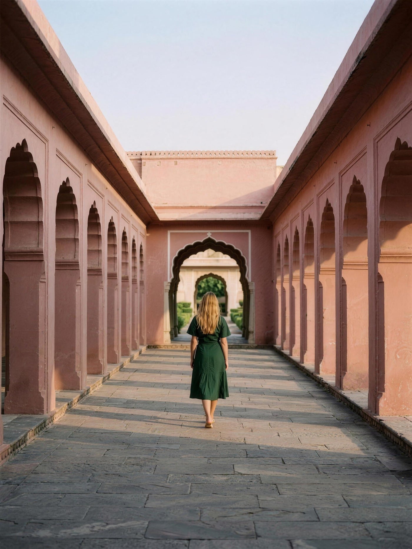 Bottle green linen wrap dress photographed in a Jaipur haveli courtyard