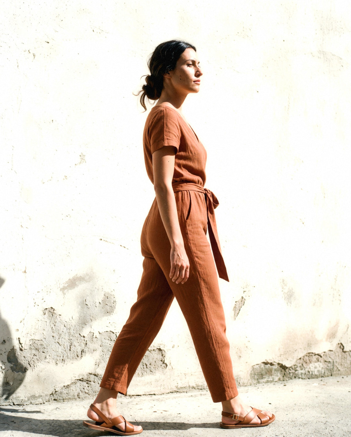 Wrap Linen Jumpsuit in cinnamon, worn outdoors