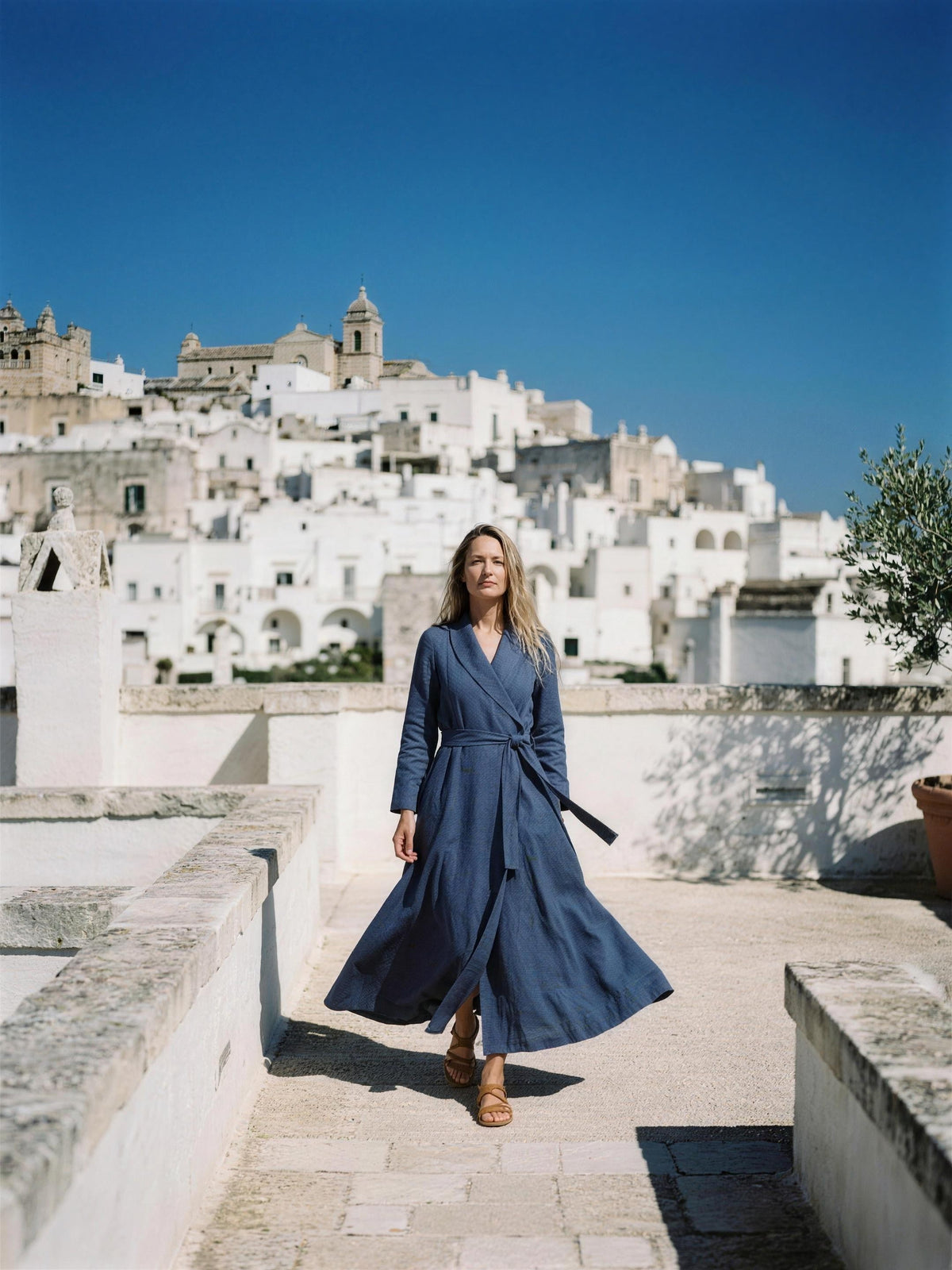 Indigo linen wrap maxi dress photographed on a whitewashed rooftop terrace
