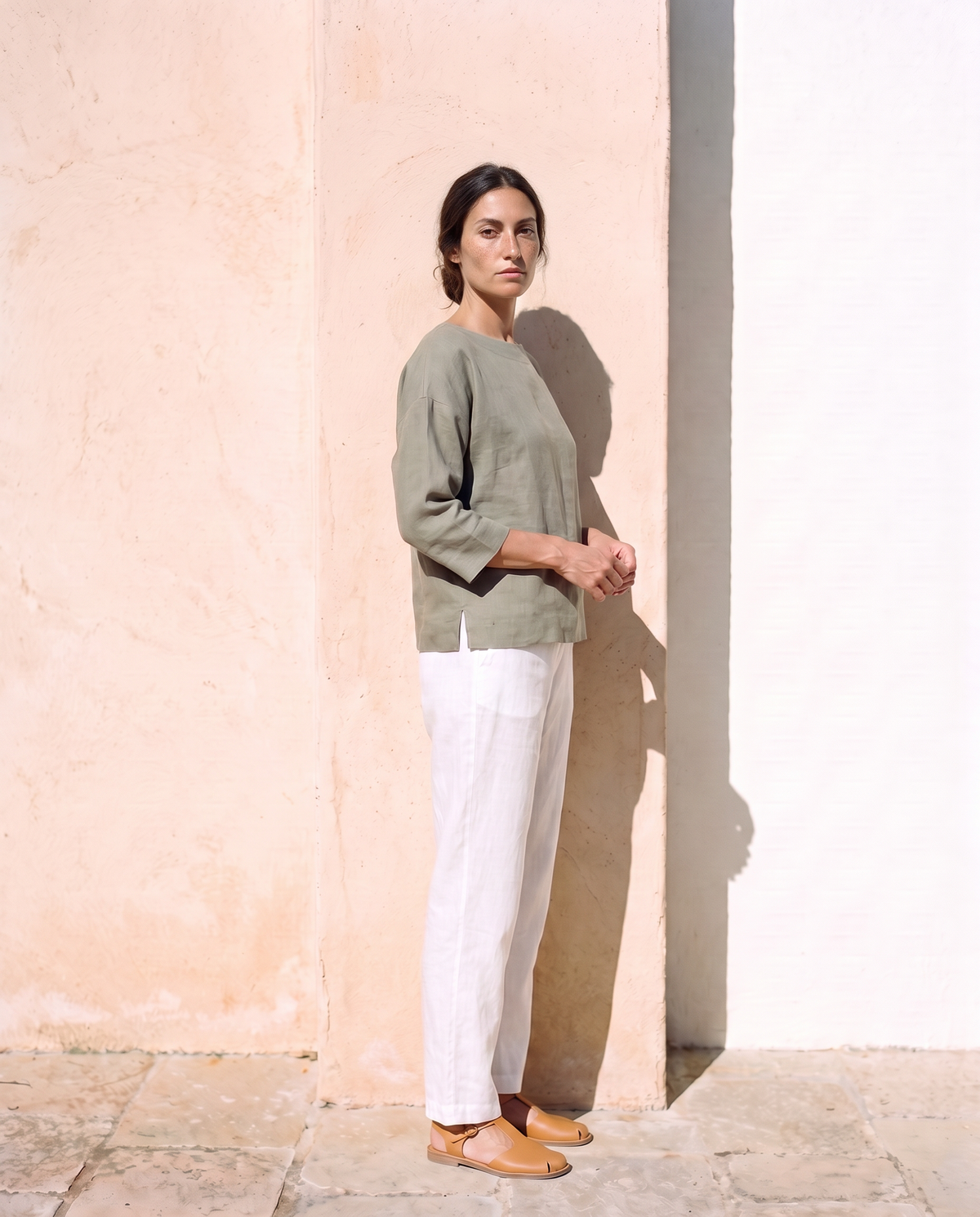 Lia Top in moss, a quarter turn, looking at the camera