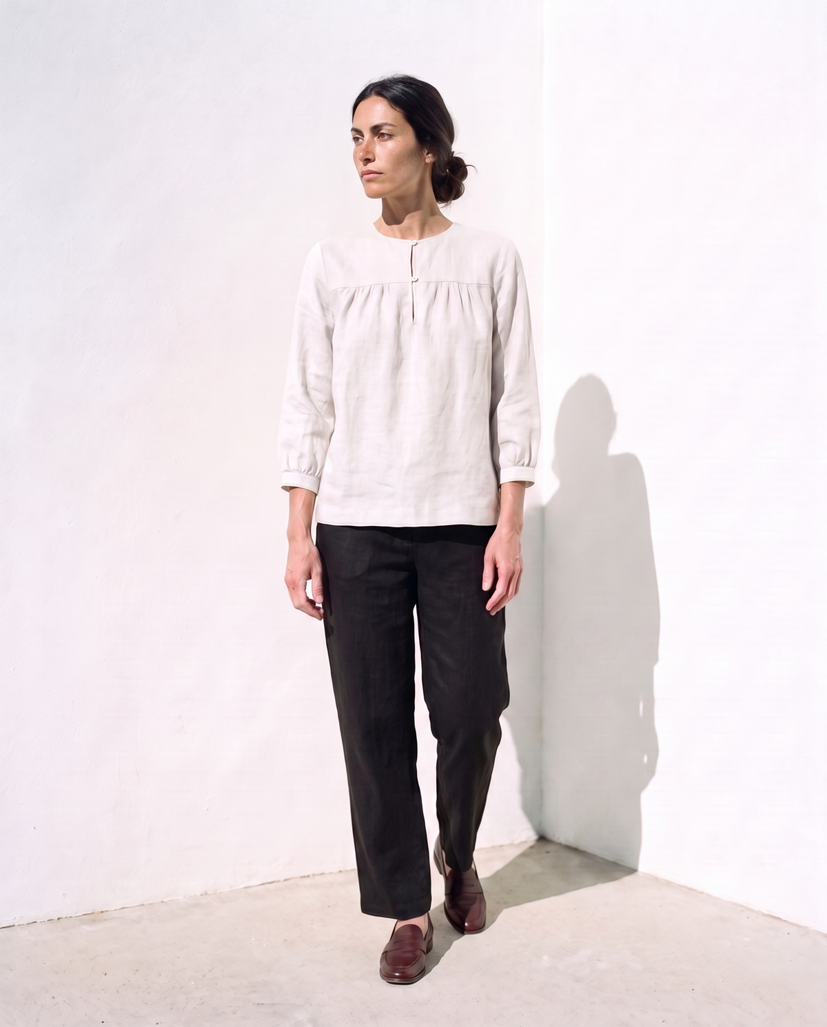 Ines Blouse in white, half a step forward, looking away