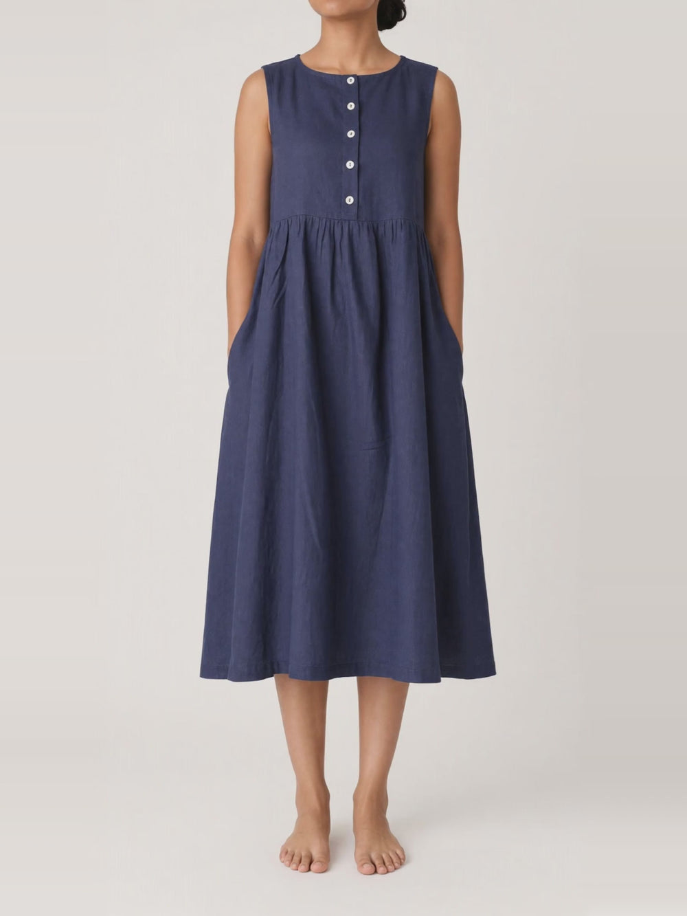 Button Front Gathered Midi in navy, turning in the studio
